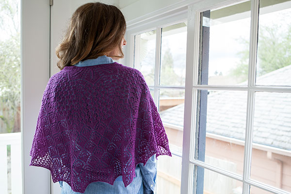 Model wearing Emperatriz Shawl in front of a window.