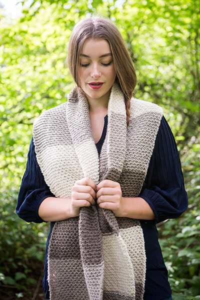 Model wearing the Simply Stripes Scarf in a forested area.