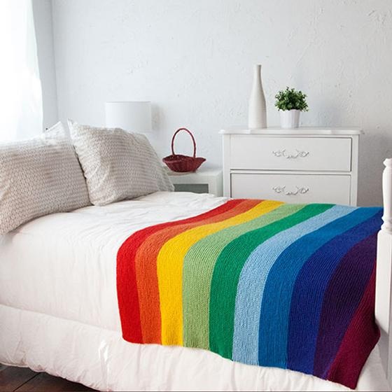 A knitted rainbow blanket made with simple stitches
