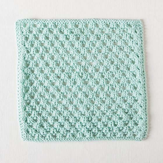 Honeycomb Dishcloth: A mint colored knitted dishcloth with a diagonal woven pattern